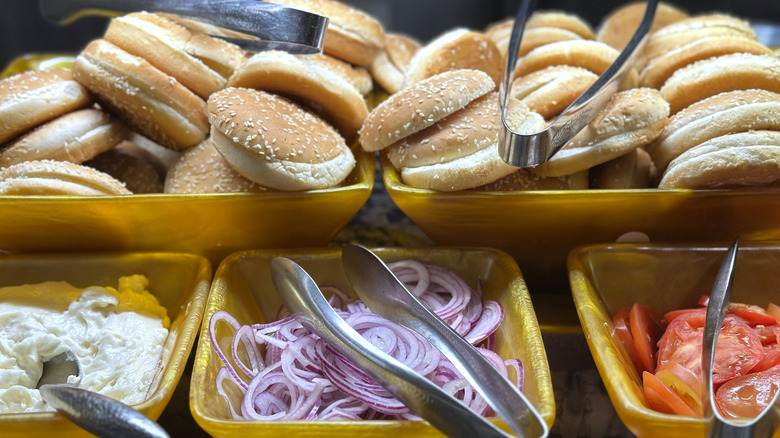 Burger bar with buns and various toppings