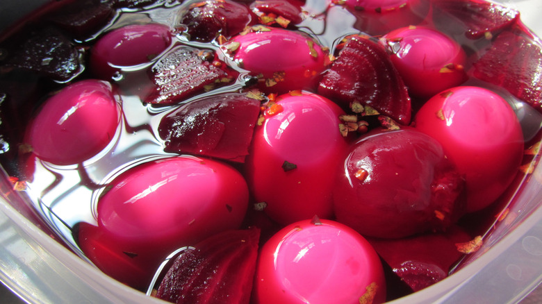 pickled eggs in brine with beet chunks