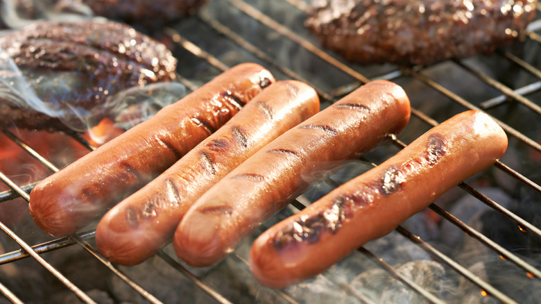 Hot dogs on a grill.