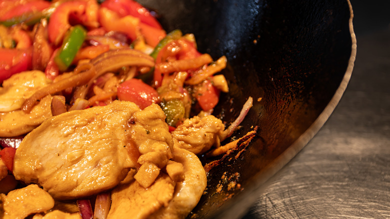 Stir-fried meats and vegetables in a wok