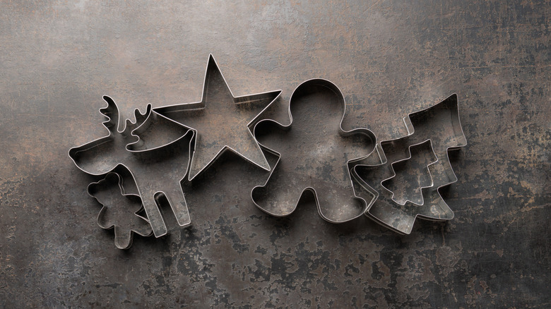 Christmas cookie cutters in star, reindeer, gingerbread, and tree shapes