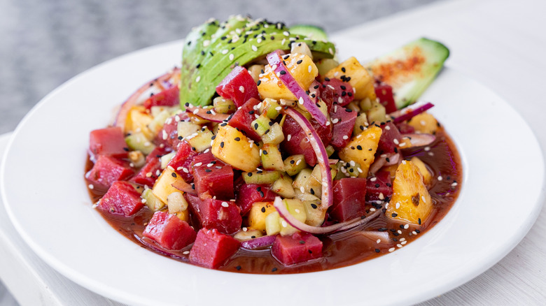 Raw tuna salad with pineapple, avocado, cucumber, and red onion