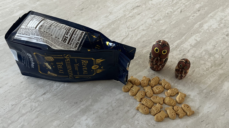 Bag of Goldfish Butterbeer Flavored Grahams spilled with two owls looking at it