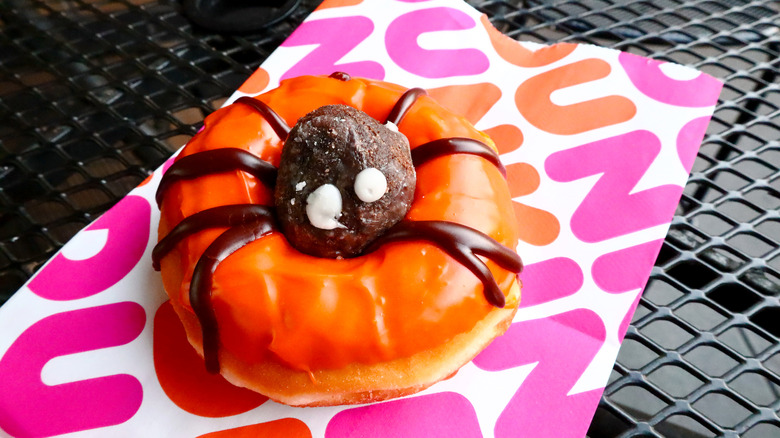 The spider donut from Dunkin' on top of a paper bag