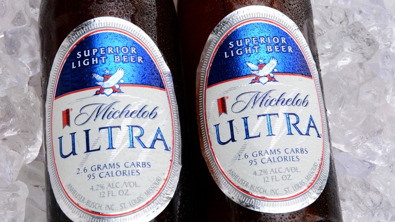 Two bottles of Michelob Ultra on ice close up