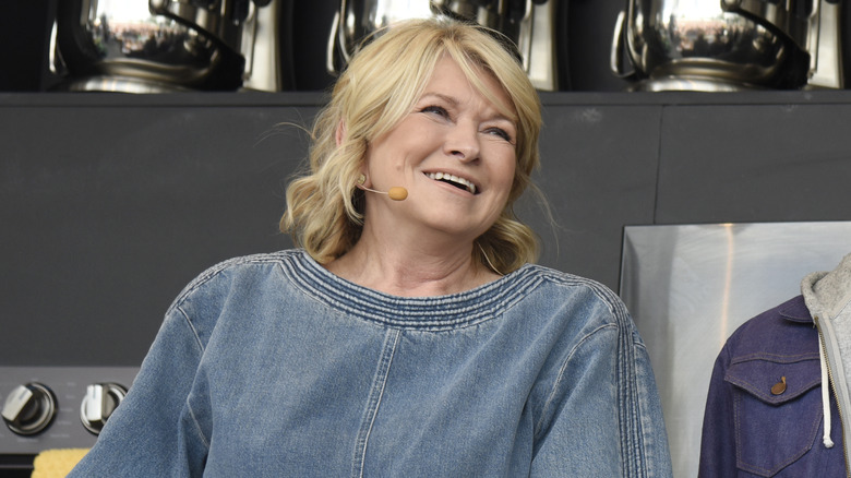 A closeup of Martha Stewart at a panel, laughing