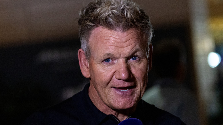 Gordon Ramsay speaking into a blue microphone