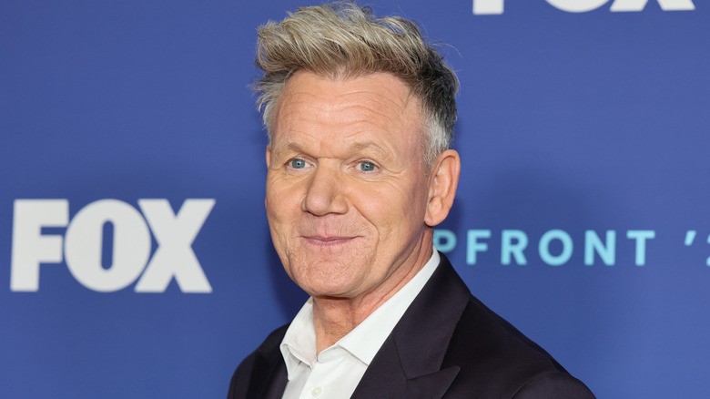 Gordon Ramsay smiling at a red carpet event with the FOX logo behind him.
