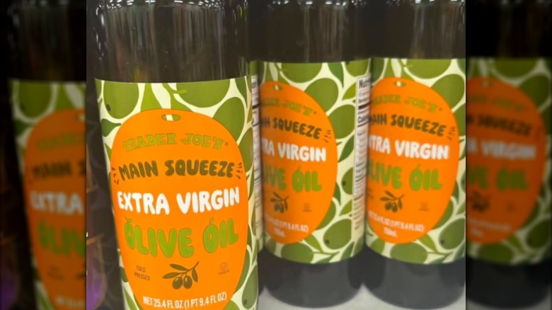 Bottles of Trader Joe's Main Squeeze Extra Virgin Olive Oil on store shelf