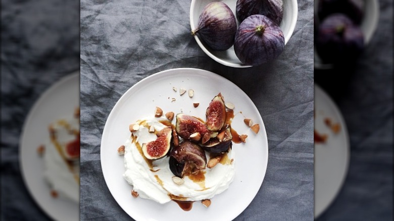 Plate with skyr yogurt, figs, nuts, and syrup drizzle