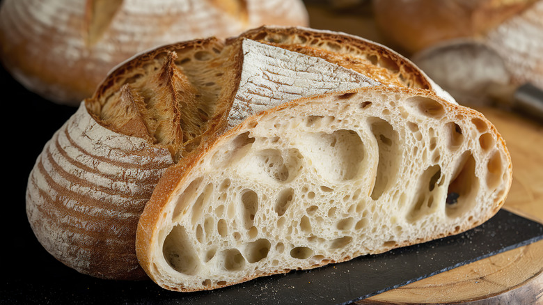 Sourdough loaf sitting on a wooden cutting board