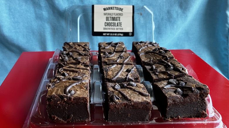 A 3x4 grid of little brownie squares on a bright red surface.