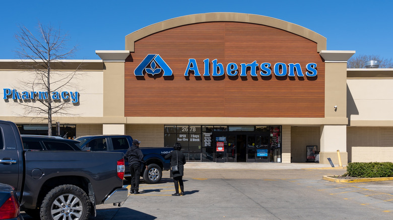 Albertsons storefront and parking lot on sunny day