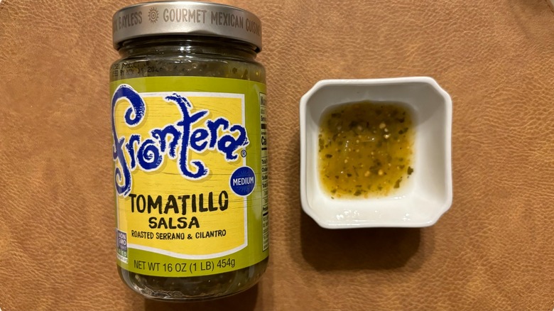Frontera Tomatillo Medium Salsa jar with salsa in white ramekin
