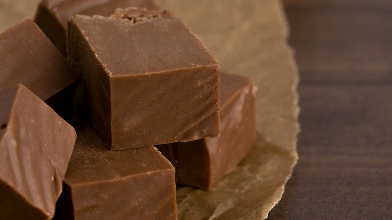 Chocolate fudge dessert cubed on a wooden counter