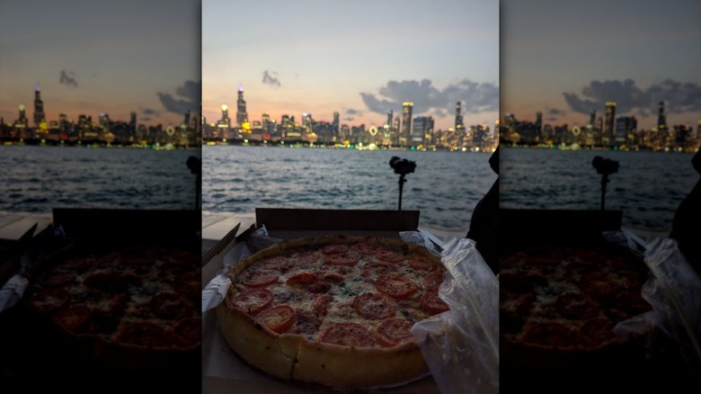 deep-dish pizza in front of Chicago skyline