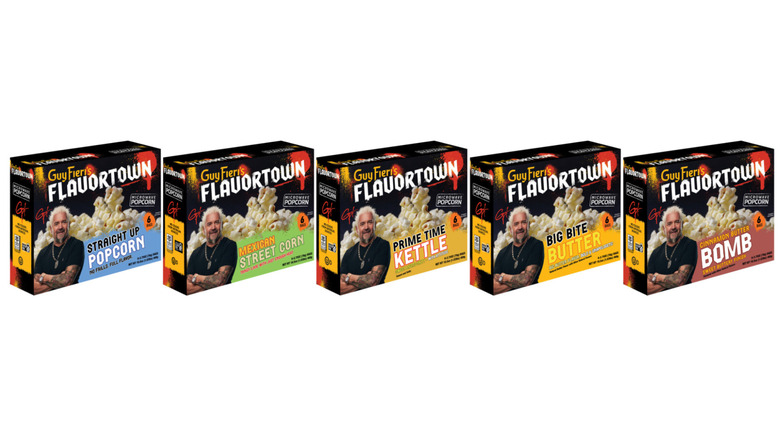 All five flavors of Guy Fieri's Flavortown popcorn in a row on a white background.