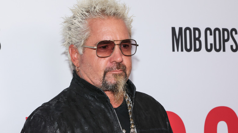 Guy Fieri at a movie event wearing sunglasses