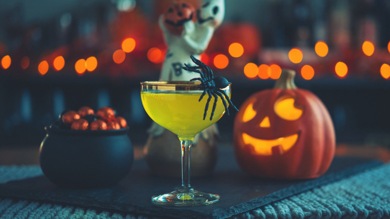 A Halloween cocktail with spider garnish