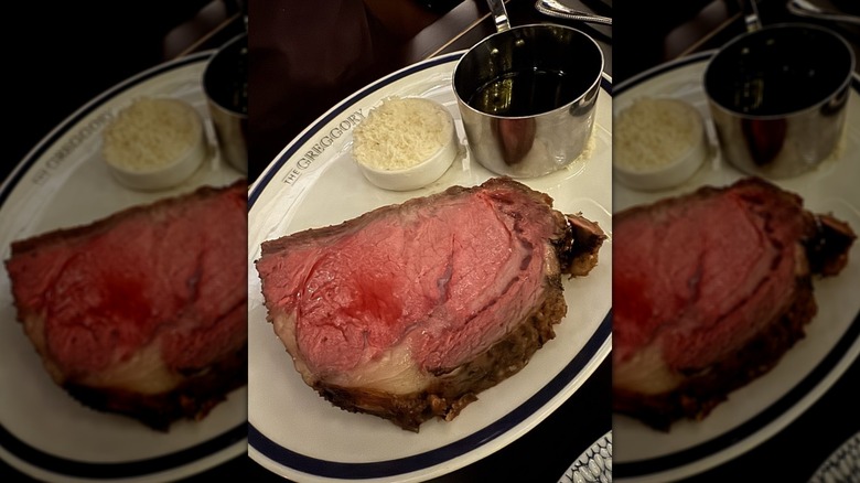 Prime rib served on a plate with au jus and horseradish at The Greggory restaurant.