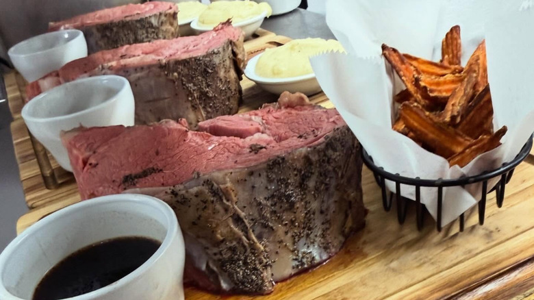 Three orders of Sweetheart Inn's 48 ounce cut prime rib on wooden serving boards.