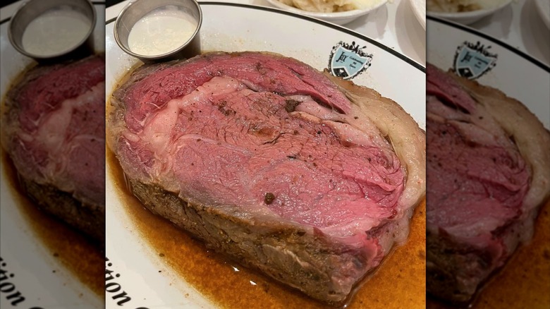 A thick prime rib steak in juices on plate at Jax Cafe.