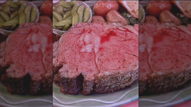 A perfectly pink slice of prime rib served with pea pods and red potatoes at Flamingo Grill.