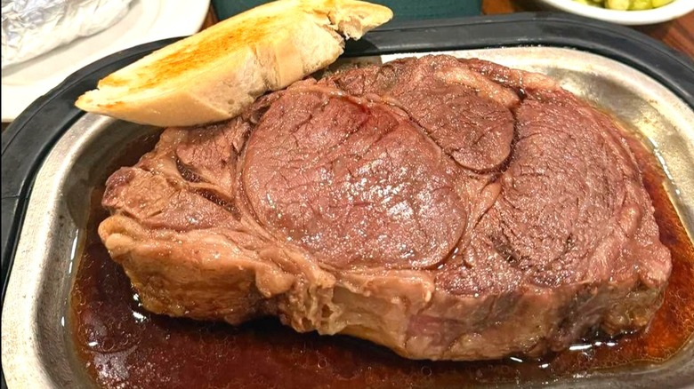 A 24 ounce cut of juicy prime rib on metallic tray at Court House Cafe.