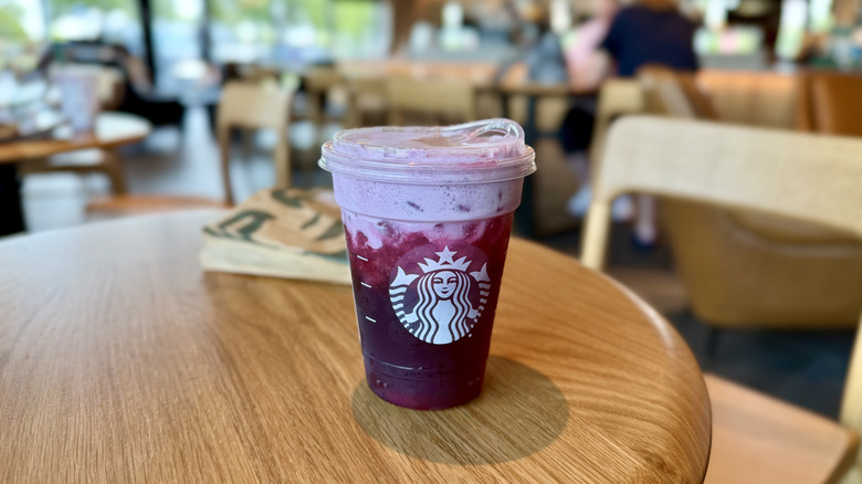 Cup of Starbucks' Hannah Montana Popstar Refresher drink on a wooden table