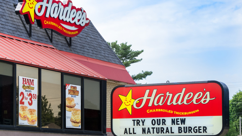 Facade of a Hardee's restaurant with its signature logo and menu display.