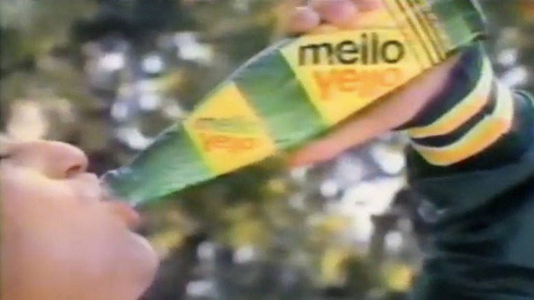 A person drinking a bottle of Mello Yello in a vintage commercial for the soda brand