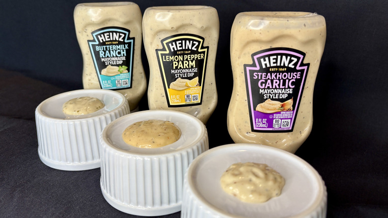 Three sauces on white dishes with Heinz bottles in background