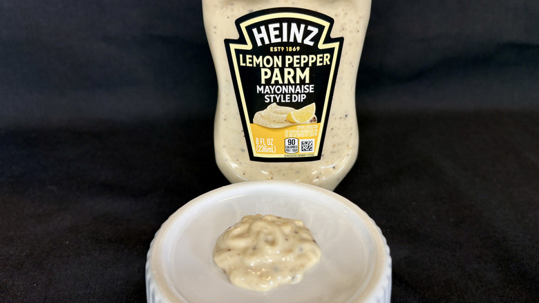 Lemon Pepper Parm sauce on white dish with Heinz bottle in background