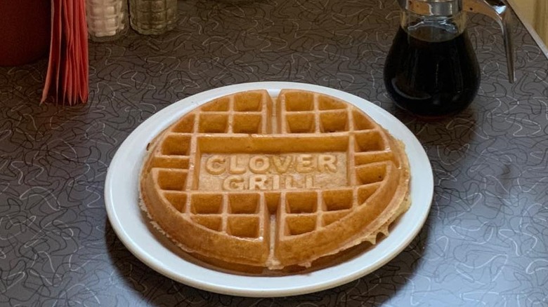 A Belgian waffle with "Clover Grill" stamped onto the top