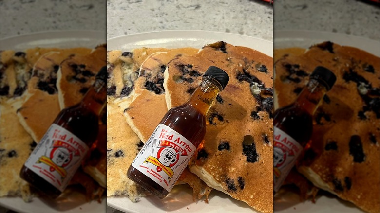 Pancakes from Red Arrow Diner with labeled syrup bottle