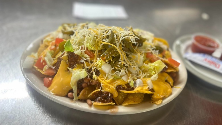A plate of loaded nachos on the table at Perry's Restaurant