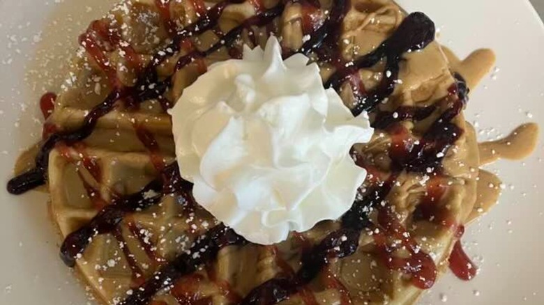 Belgian waffle topped with syrups and whipped cream from Mandy's Family Restaurant