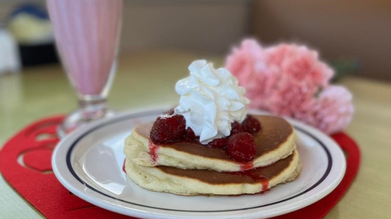 Stack of pancakes with strawberries and whipped cream from IHOP