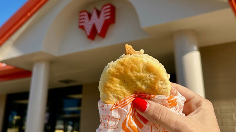 Female hand close up, holding a chicken biscuit from Whataburger