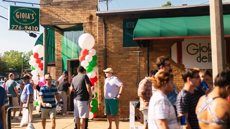 Exterior of Gioia's Deli with people out front