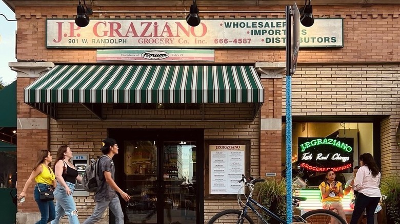 Exterior of J.P. Graziano Grocery in Chicago with people walking past