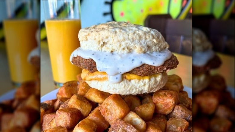 Vegan chicken biscuit with gravy and potatoes and orange juice from Green New American in Arizona