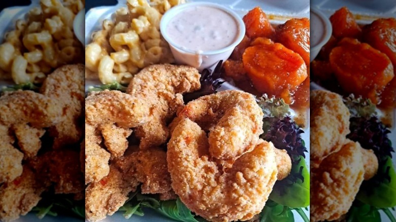 A plate of vegan fried chicken, mac and cheese, yams/sweet potatoes, and sauce from The HOME in Little Rock, Arkansas