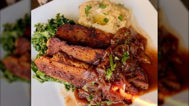 Vegan meat with caramelized onions, greens, and mashed potatoes from ION Restaurant in Middletown, Connecticut