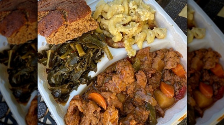 A plate of vegan meat, greens, mac and cheese, and cornbread from The Land of Kush in Baltimore, Maryland