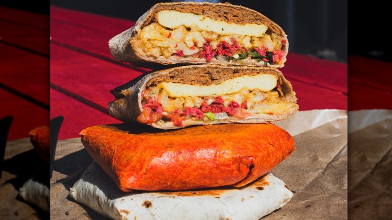 Stack of vegan crunch wraps filled with vegan meat and potatoes from The BE-Hive in Nashville, Tennessee