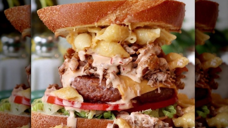 Vegan sandwich with burger patty, mac and cheese, lettuce, tomatoes, and sauce from Devil's Lettuce in Henrico, Virginia
