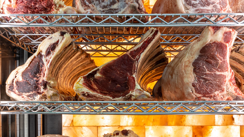 Dry-aged steaks on a metal rack