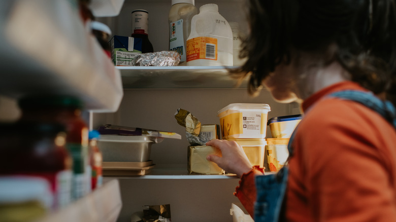 Open fridge with dairy products.