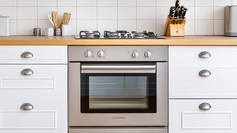 Kitchen counter with oven in the center and drawers on either side.